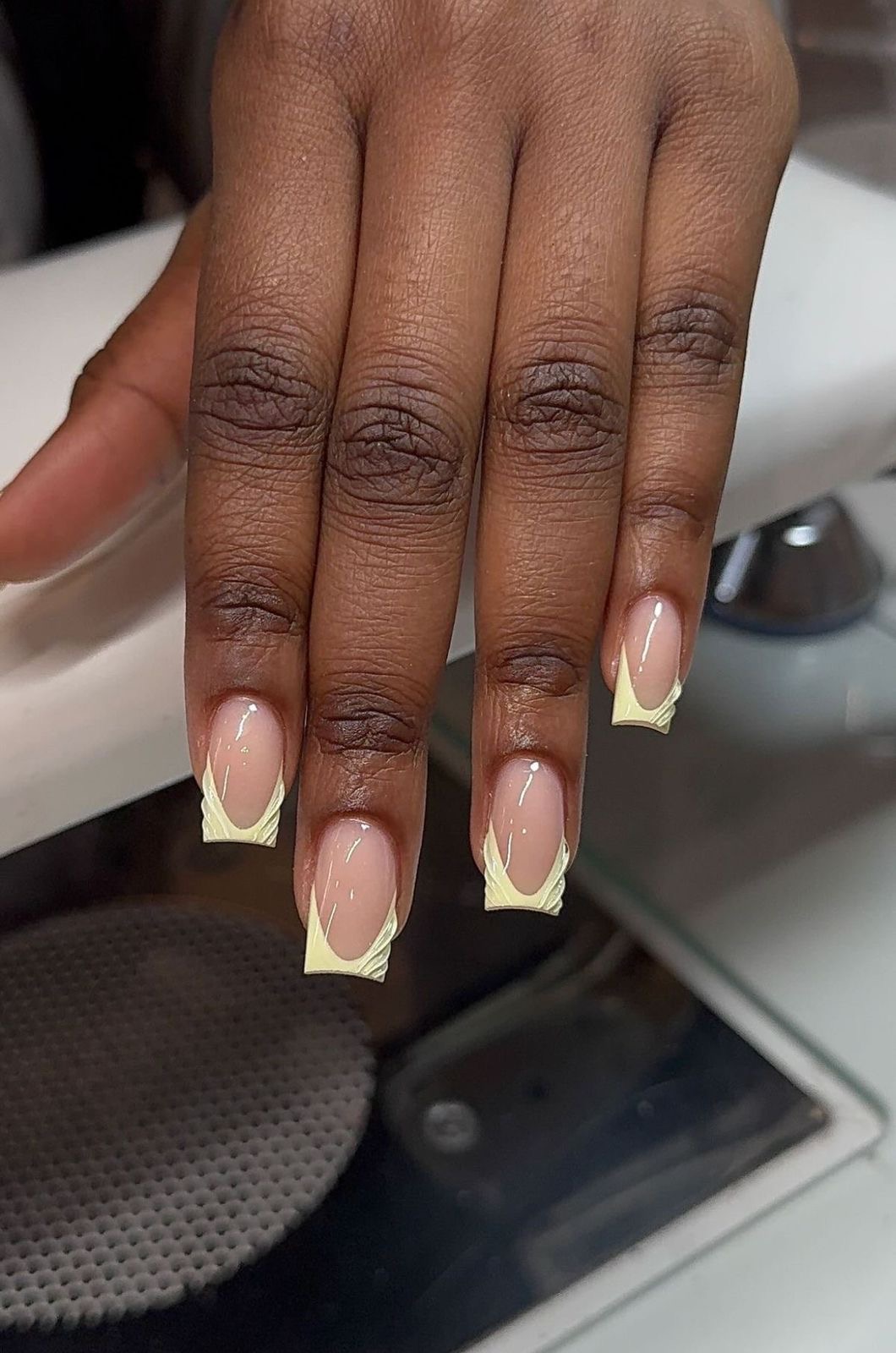 Yellow French tip swirl nails
